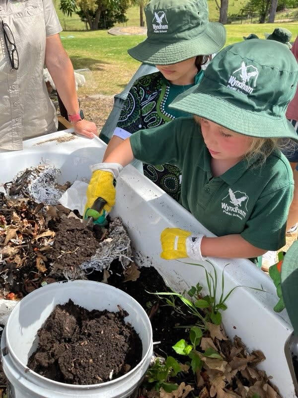 students planting in garden